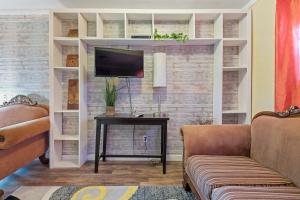 a living room with a tv and a table at Cocoplum Rest N Hideaway #1 in Nassau