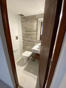 a bathroom with a toilet and a sink at HAUS APARTAMENTOS in Salta