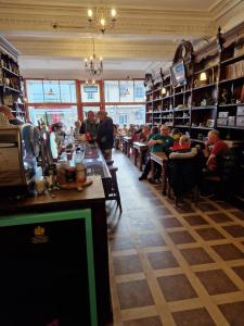 a bar in a restaurant with people sitting at tables at Aberfoyle Inn in Aberfoyle