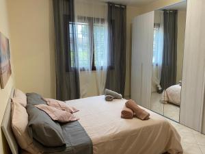 a bedroom with a bed and a large mirror at Villa Marcosimone in Guidonia