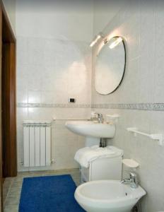 a bathroom with a sink and a toilet and a mirror at Villa La Tinaia Il Sole Verde in Bucine