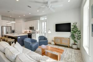 a living room with a white couch and a kitchen at Beaches and Bunkers in Port Aransas