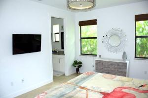 a bedroom with a bed and a tv in a room at Beautiful and relaxing villa near the Beach! in Naples
