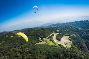 a group of people flying a parachute in the sky at Casa del Cerro San Javier in Yerba Buena