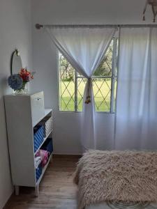 a bedroom with a bed and a window at Casa del Cerro San Javier in Yerba Buena