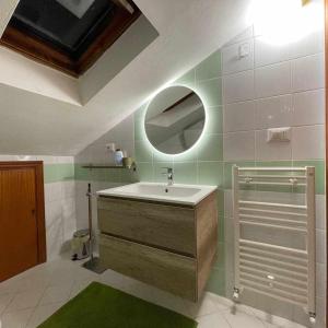 a bathroom with a sink and a mirror at Milordo Gubbio Apartment in Gubbio