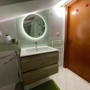a bathroom with a sink and a mirror at Milordo Gubbio Apartment in Gubbio +27 photos