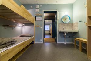 a bedroom with a bunk bed and a sink at STF Abisko Turiststation in Abisko