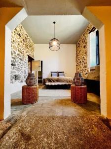 a bedroom with a bed and two tables in a room at El Quinto de Luciañez in Ventas con Peña Aguilera