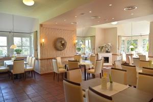 a restaurant with tables and chairs and a fireplace at Marienthaler Gasthof in Marienthal
