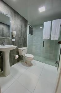 a bathroom with a toilet and a shower and a sink at Calypso Beach Hotel by The Urbn House Santo Domingo Airport in Boca Chica