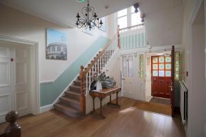 a hallway with a staircase and a stair case at 100 Banbury Road Oxford - formerly Parklands in Oxford