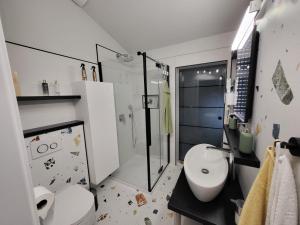 a bathroom with a toilet and a sink and a shower at ANTICA in Vrh nad Želimljami +14 photos