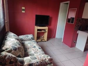 a living room with a couch and a flat screen tv at Cabañas Buin in Puerto Montt
