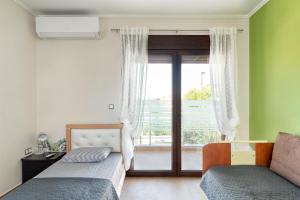 a bedroom with a bed and a window with a view at Villa Zen New Plagia Chalkidiki in Nea Plagia