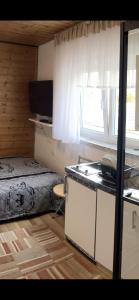 a bedroom with a bed and a desk and a window at Euro S Markt in Biberach an der Riß