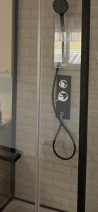 a shower with a hose attached to a wall at Euro S Markt in Biberach an der Riß