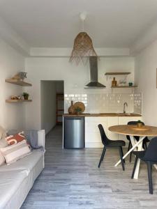 a living room with a couch and a table and a kitchen at CASA MAMA CARINA in Agüimes