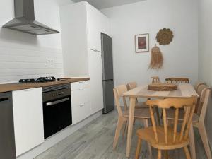 a kitchen with a table and chairs and a stove at CASA MAMA CARINA in Agüimes +36 photos