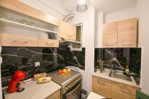 a kitchen with a sink and a counter top at Modern, comfortable apartment, in the heart of the city_2 in Larisa