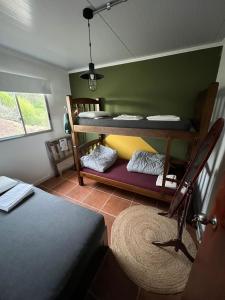 a room with two bunk beds and a rug at La Cañada in Minas