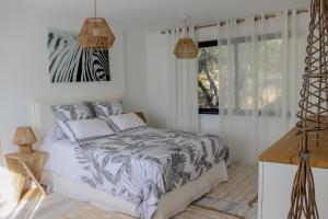 a bedroom with a bed with a zebra print sheets at Chambre d'hôtes A Vadina Porticcio in Porticcio