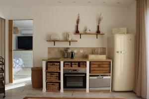 a kitchen with a refrigerator and a stove at Chambre d'hôtes A Vadina Porticcio in Porticcio