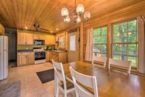 a kitchen with a wooden ceiling and a table and chairs at Cozy Riverfront Getaway Fishing On-Site! in Lacon