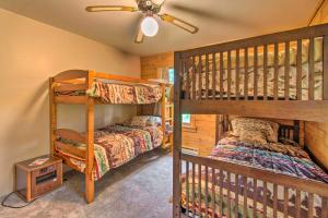 a bedroom with two bunk beds and a ceiling fan at Cozy Riverfront Getaway Fishing On-Site! in Lacon