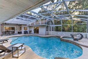 una piscina cubierta con techo de cristal en Stunning Space Coast Getaway with Backyard Oasis!, en Titusville