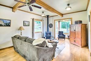 a living room with a couch and a ceiling fan at Quaint Coquille Getaway Near Beaches and Parks! in Coquille