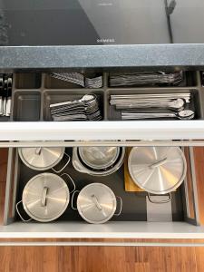 a drawer filled with plates and utensils at Ferienwohnung am Alexbad in Bad Alexandersbad