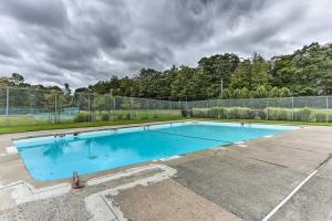 an empty swimming pool with a fence around it at Lakefront Catskills Getaway with Private Deck! in Forestburgh