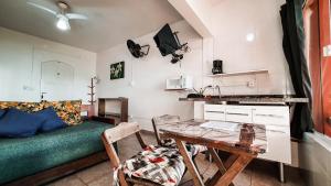 a living room with a table and a couch at Pousada Ubatuba do Alto in Ubatuba