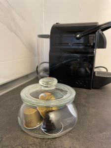 a glass jar of food in front of a toaster oven at Daisy House in Ferrara
