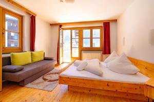 a living room with a wooden bed and a couch at das Cityhouse in Mayrhofen
