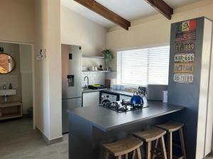 a kitchen with a large island in the middle of it at Kabeljauws Beach Estate in Jeffreys Bay