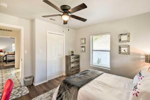 a bedroom with a bed and a ceiling fan at Lovely Historic Fort Worth Home about 6 Mi to Dtwn! in Fort Worth