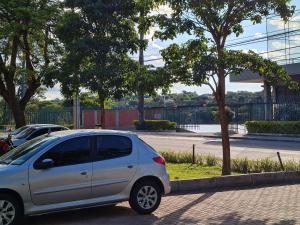 una piccola auto argentata parcheggiata in un parcheggio di Hotel San Diego Pampulha - Flats Particular a Belo Horizonte