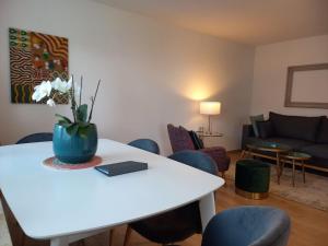 a living room with a table with a vase of flowers on it at Apartment Gästehaus Maria in Rettenbach am Auerberg