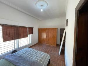 a bedroom with a bed and a window at Al Mattal in Amman