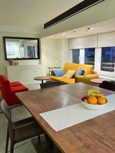 a living room with a table with a bowl of fruit on it at Apartamento Lina, a 20 metros de la playa in Lloret de Mar