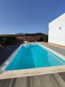 a swimming pool with blue water in a house at Casa Bermeja - Tiscamanita in Tiscamanita
