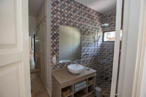 a bathroom with a sink and a mirror at Villa Mayaz - Piscine chauffée in Marrakech +20 photos