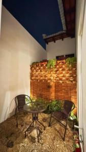 a patio with a table and two chairs and a brick wall at Cozy Bohemian Loft Apartment close Central Plaza in Antigua Guatemala