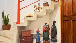 a stairway with figurines of people on the floor at Cozy Bohemian Loft Apartment close Central Plaza in Antigua Guatemala