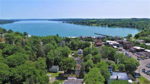an aerial view of a town next to a lake at 34 State "Historic Luxury Suites" Skaneateles in Skaneateles