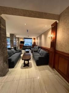 a large living room with couches and a large screen tv at فندق كنان العزيزية Kinan Al Azizia Hotel Makkah in Makkah