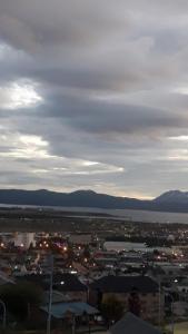 a view of a city with buildings and the water at MyR alojamiento in Ushuaia