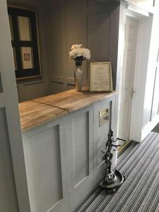 a room with a counter with a vase with flowers on it at The Willows in Brighton & Hove